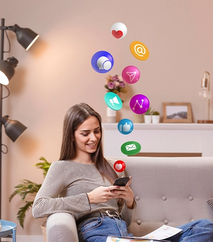Woman using phone with social media icons floating
